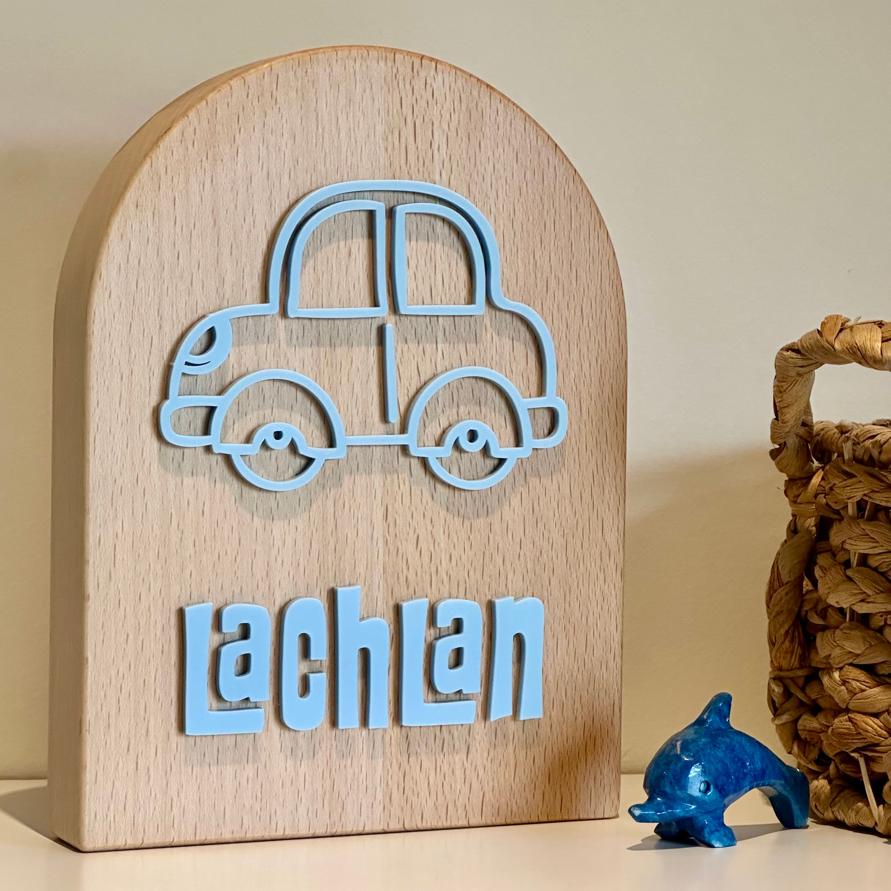 A child's money box in an arch shapee with a car design on  it, personalised with a child's name