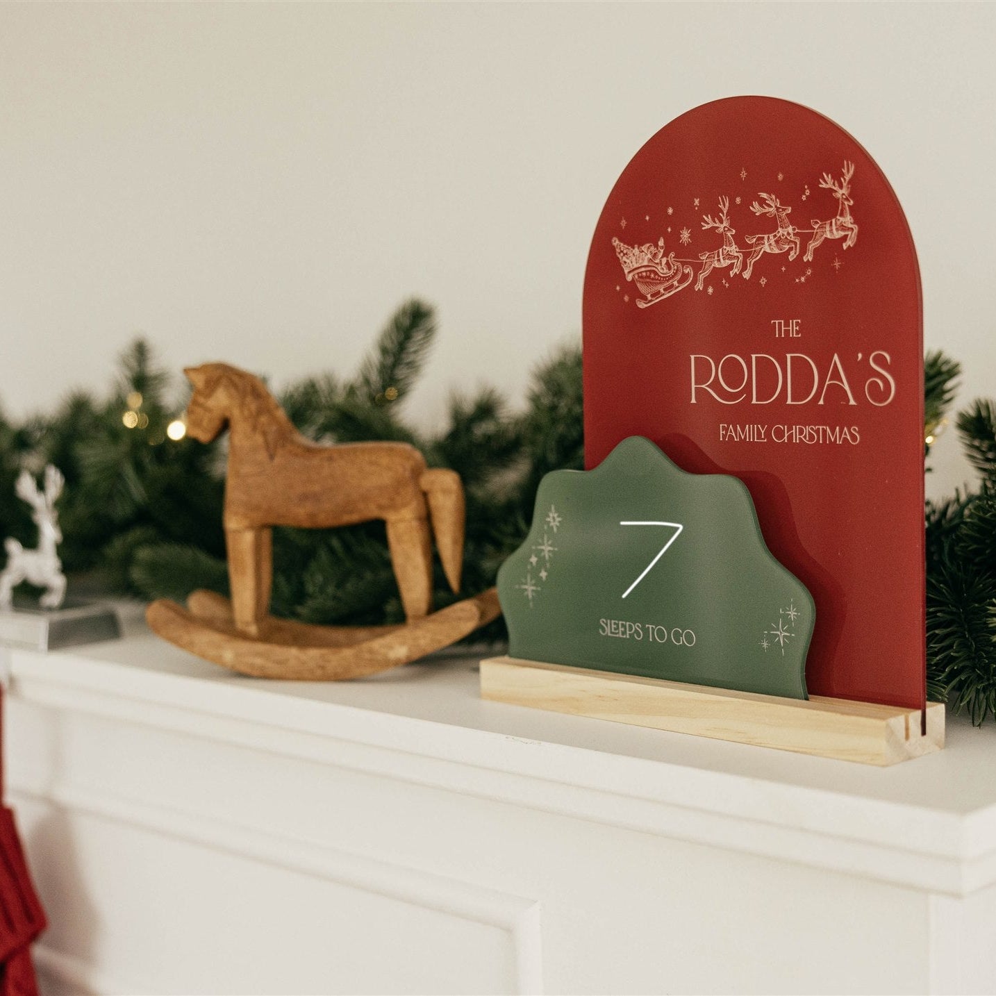 Christmas-themed decor with a red and green coundown  calendar on a mantelpiece.
