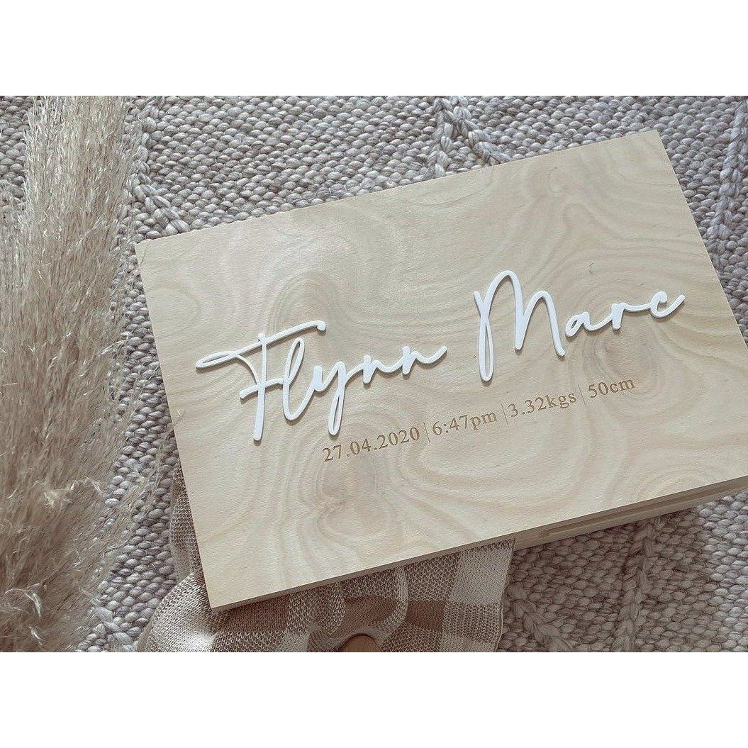 A wooden keepsake memory box with acrylic lettering on the lid, displaying a name and a date.
